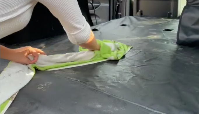 woman cleaning a Jeep Grand Cherokee Cargo Liner